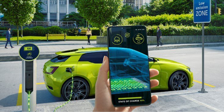 A bright green electric car is parked at a charging station in a low-emission zone. 