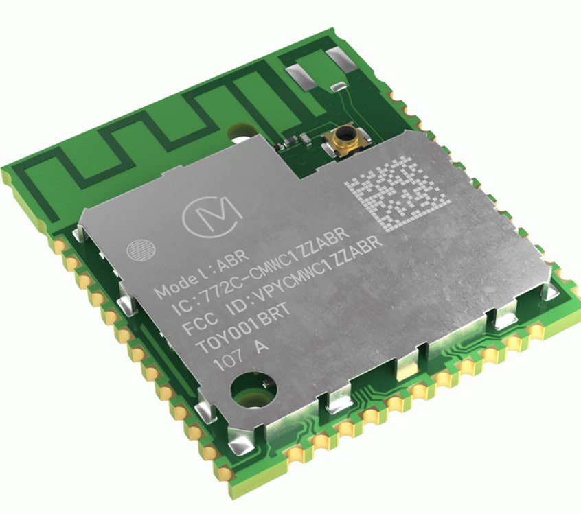 A small electronic wireless module featuring a metallic shield with engraved text and QR code. 