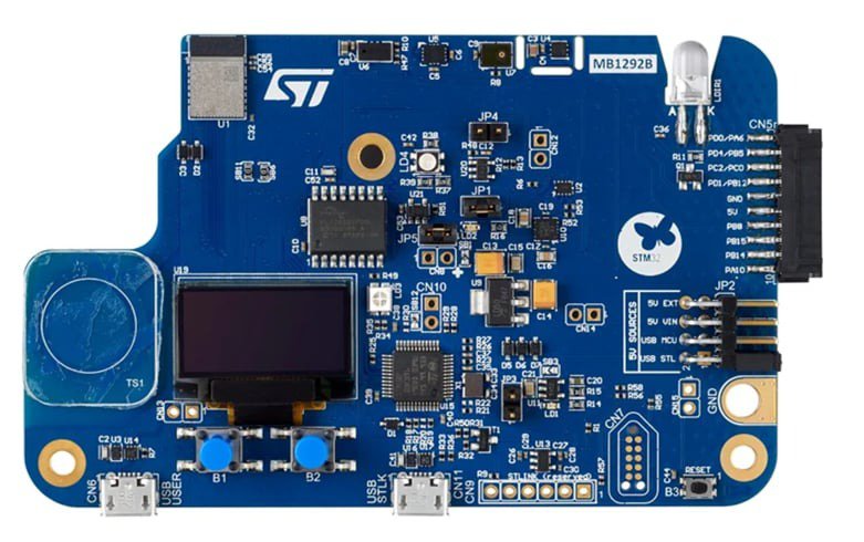 A blue ST Microelectronics development board featuring various electronic components and connectors.