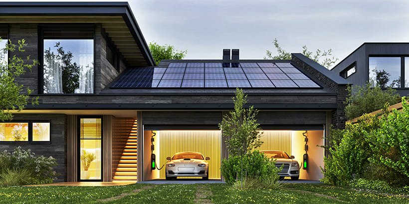 Modern two‑story house with rooftop solar panels and a green yard, featuring two electric cars charging in illuminated garage bays, illustrating residential solar power generation integrated with home energy storage and EV charging.