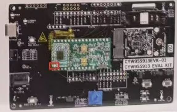 A detailed image of a CYW955913EVK-01 evaluation kit circuit board is shown. The board features various electronic components, connectors, and a green module mounted at the center.