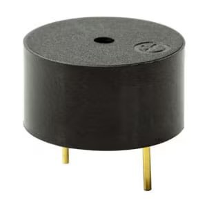 A small, round black electronic buzzer is shown with two gold-colored metal pins extending from the bottom. The buzzer features a central hole on the top surface and a subtle marking on one side.