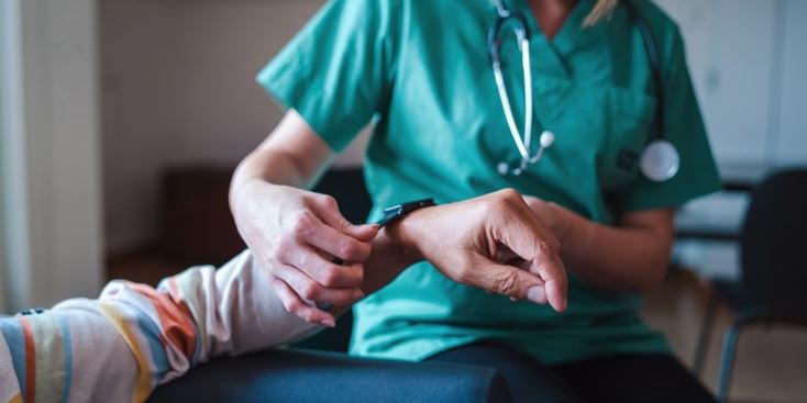 Image of nurse assisting patient with smart watch