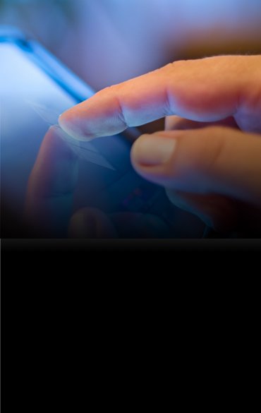 A close-up image shows a person's finger touching the screen of a digital device, likely a tablet or smartphone. 