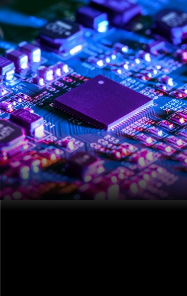 Close-up view of a computer circuit board with illuminated microchips and electronic components in blue and purple lighting.