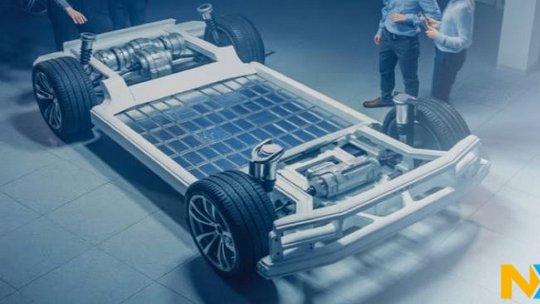 A detailed view of an electric vehicle chassis showcasing its internal components, including battery and drivetrain. 