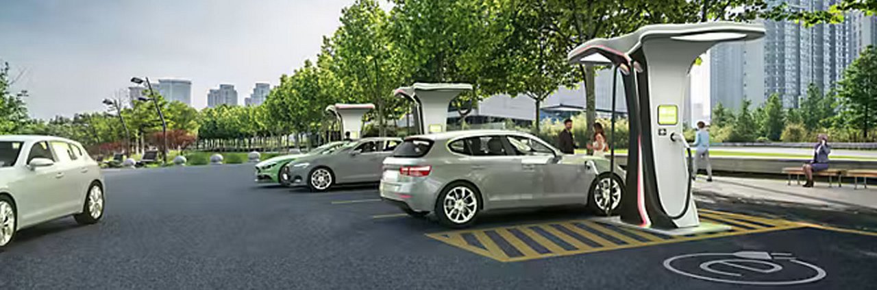 Multiple electric vehicles are parked and charging at a modern outdoor charging station. 