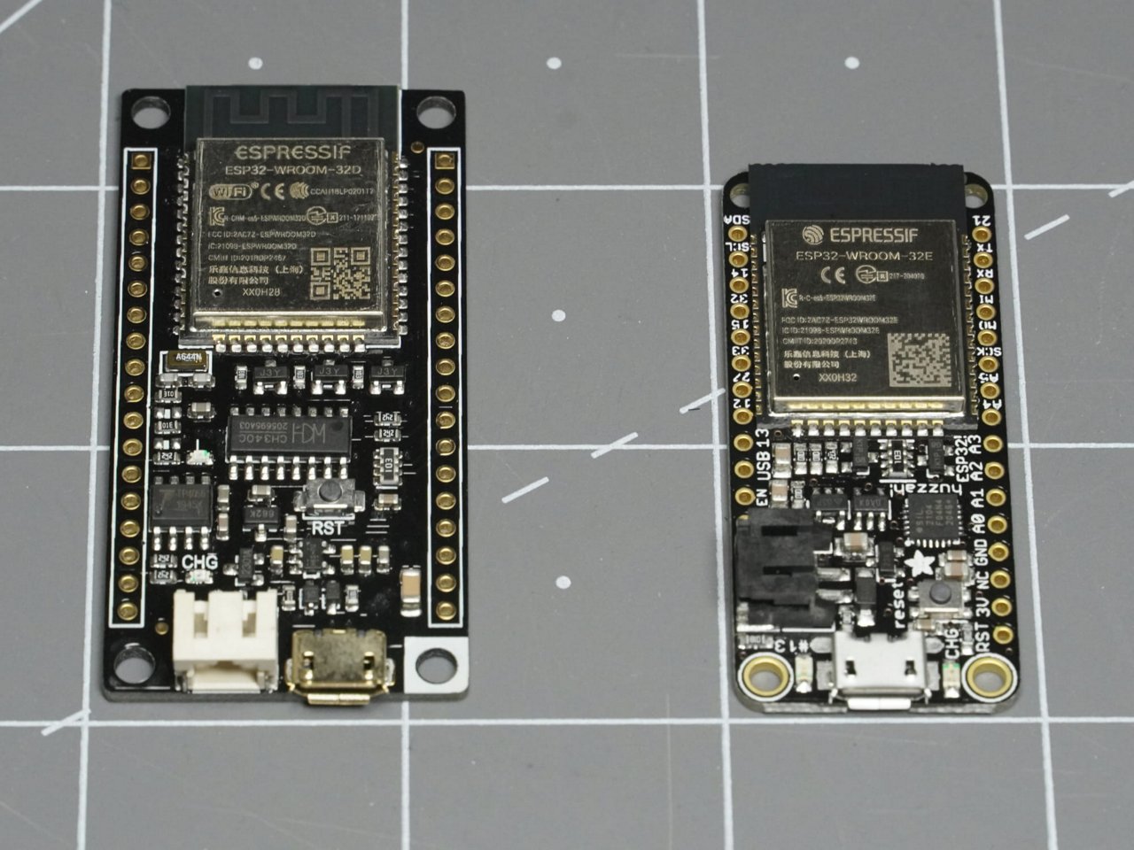 Two ESP32 development boards displayed side by side, showing different board layouts, ESP32 modules, USB connectors, and pin headers.