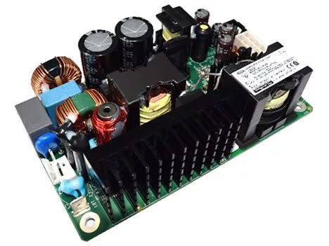 An open-frame power supply circuit board featuring various electronic components such as capacitors, inductors, and heat sinks, highlighting the detailed arrangement of parts.