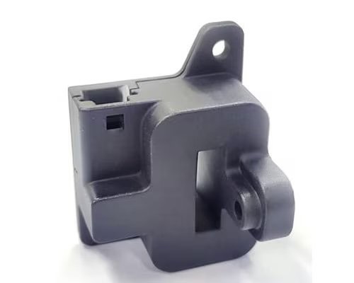 A close-up image of a black plastic automotive sensor or actuator component.