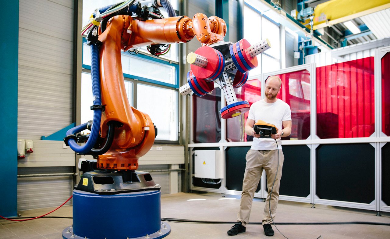 Industrial robot with operator in factory