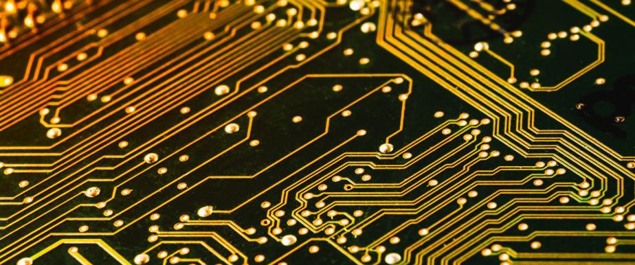 A detailed view of a microchip embedded on a circuit board, showcasing intricate electronic components and connections. 