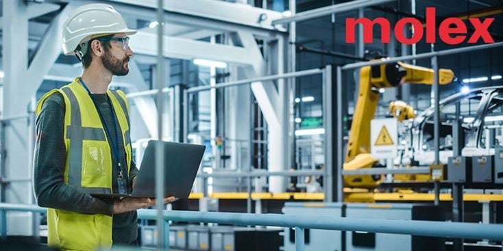 Industrial worker holds a laptop in a modern industrial factory