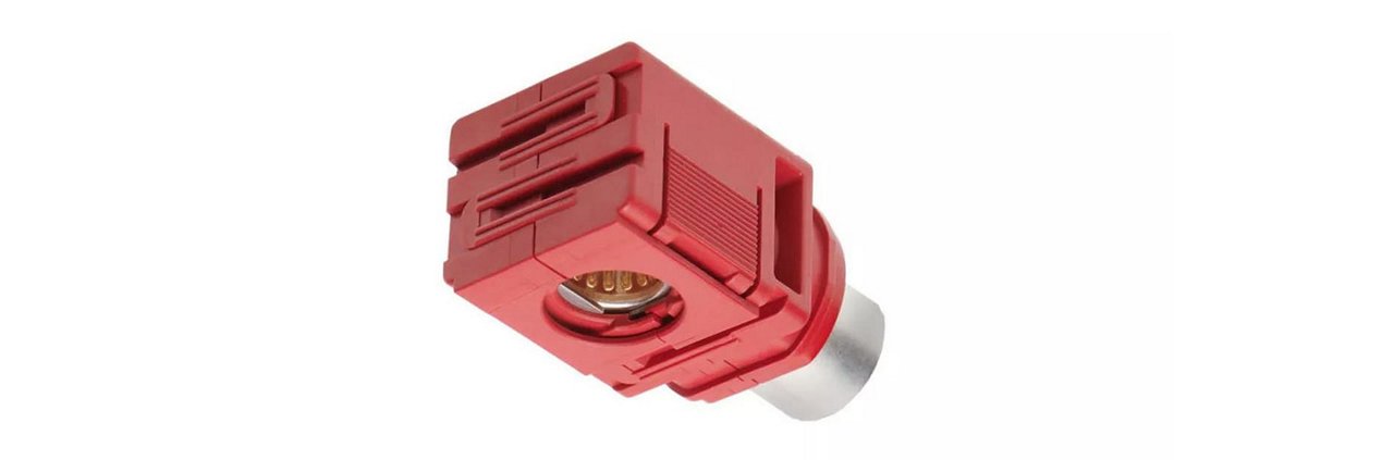 A red electrical connector featuring a metallic pin and detailed grooves.