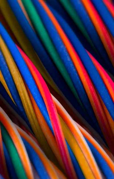 A tight closeup shows a bundle of multicolored cables or wires arranged in parallel lines.