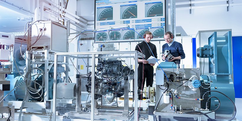 Engineers checking application of wireless sensing solutions in factory automation