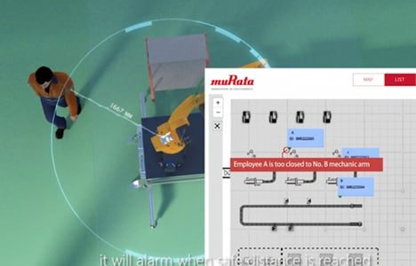 A robotic arm operates in a controlled workspace, monitored by a safety alert system