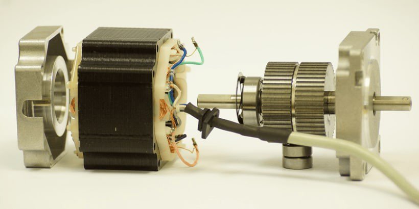 A close-up view of a disassembled stepper motor showcasing its internal components, including wiring and gears