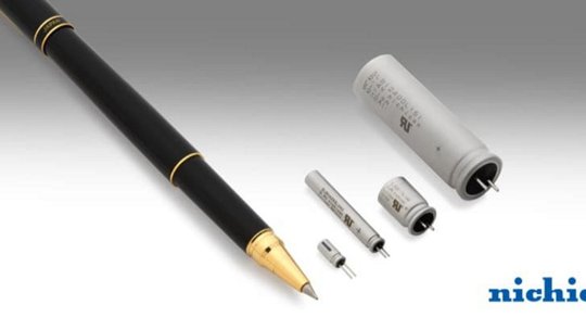 A collection of Nichicon capacitors displayed alongside a black fountain pen with gold accents