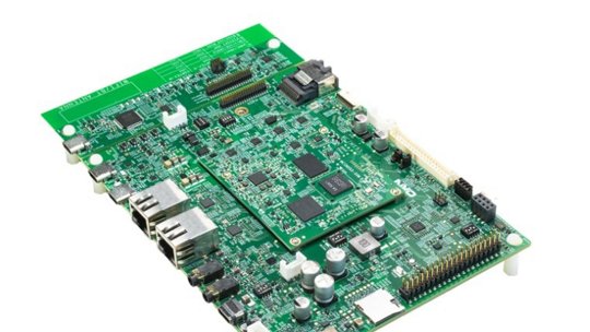 A detailed green circuit board featuring various electronic components, including chips, capacitors, and connectors