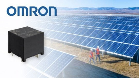 A black Omron relay is prominently displayed alongside a vast solar panel field. T
