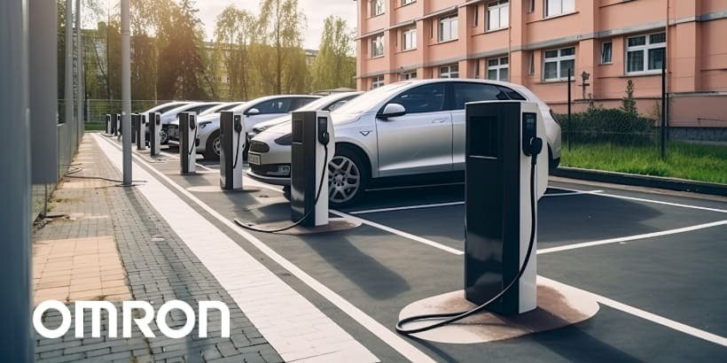 A row of electric vehicles parked at a modern charging station in an urban setting