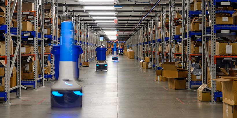 Automated robots in warehouse storage aisle