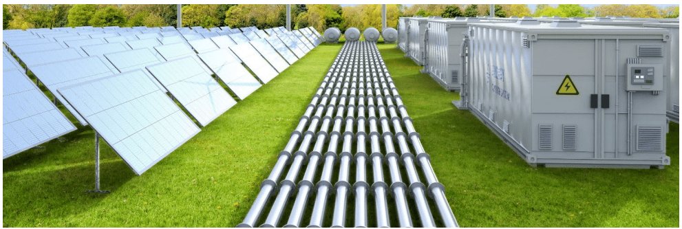 A large array of solar panels is installed on a grassy field, aligned in neat rows.