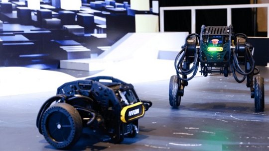 Two advanced robotic devices are displayed in a futuristic setting, featuring sleek designs and dynamic mobility