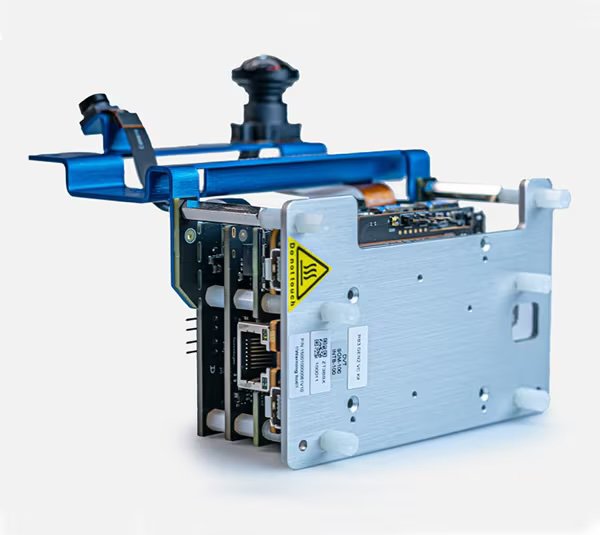 A close-up view of an industrial electronic module featuring an exposed circuit board and various connectors.