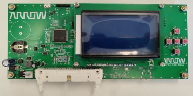 A green printed circuit board features a prominent LCD display on the right side and several red push buttons.