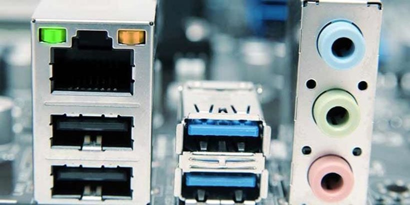 Computer motherboard ports, including network, USB, and audio jacks.