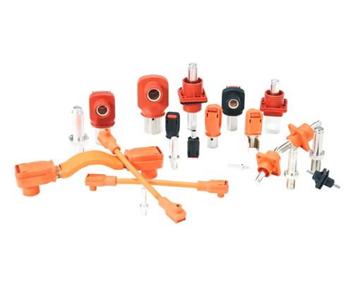 A collection of orange and silver electrical connectors and components is arranged on a white background. The assortment includes various plug types, terminals, and insulated housings, all designed for industrial or automotive applications. 