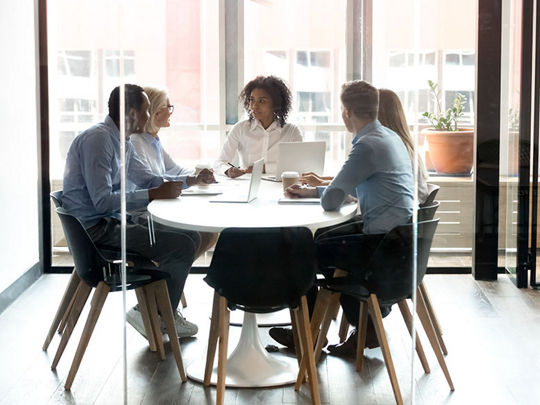 Business team behind glass door