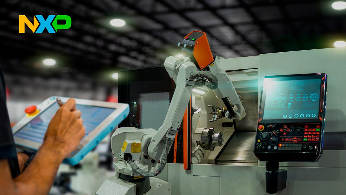 A technician uses a digital tablet to control an industrial robotic arm attached to a CNC machine. 