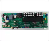 A detailed view of an electronic circuit board featuring multiple capacitors, resistors, and connectors.