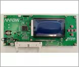 A green printed circuit board features a rectangular digital display and several red push buttons. The board includes visible electronic components and a clearly marked 'ARROW' text in the upper left corner.