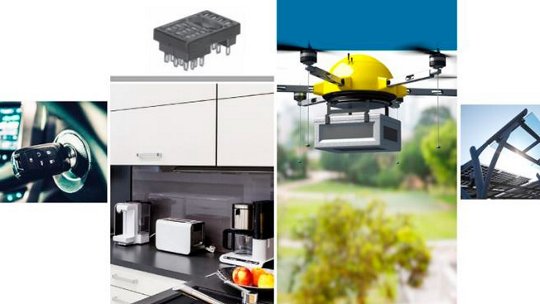 A yellow drone carrying a package is shown flying outdoors in a park-like setting