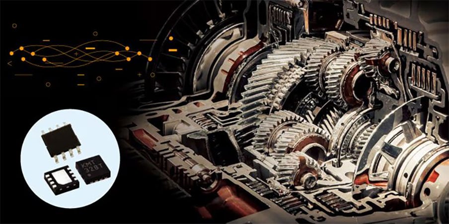 Close-up of automotive transmission gears and electronic components, including small circuit boards.