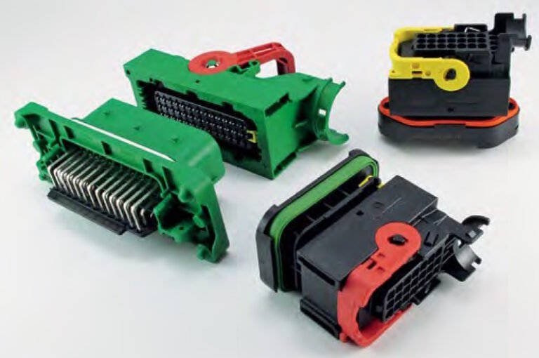 A set of electrical connectors featuring distinct color-coded components in green, red, yellow, and black. 