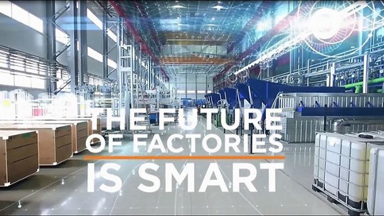 A spacious, high-tech factory interior showcasing advanced machinery and automation systems. The text overlay reads 'The Future of Factories is Smart,' emphasizing innovation and efficiency. 