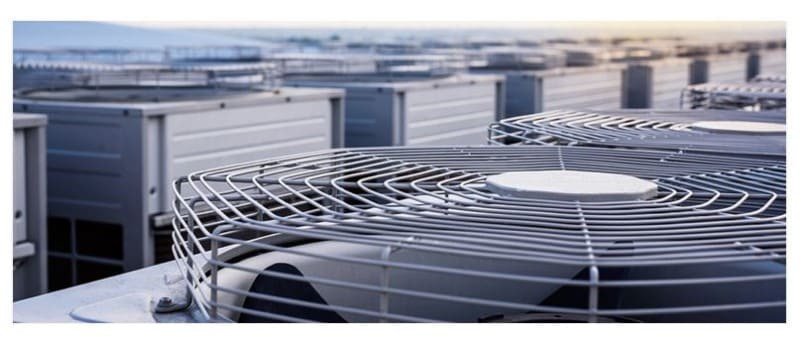 A close-up view of multiple industrial HVAC units arranged outdoors.