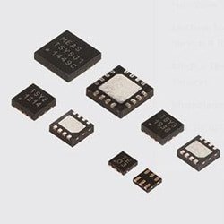 A collection of microchips displayed on a neutral background. The chips vary in size and feature visible numeric labels such as 'MEAS 15401' and 'TSY 1398'.