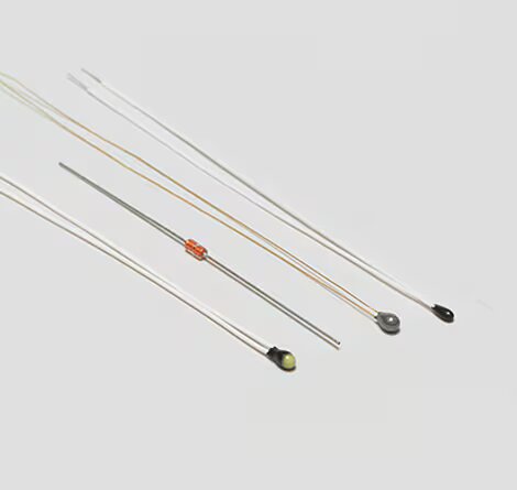 The image shows several slender electronic components arranged on a light gray background