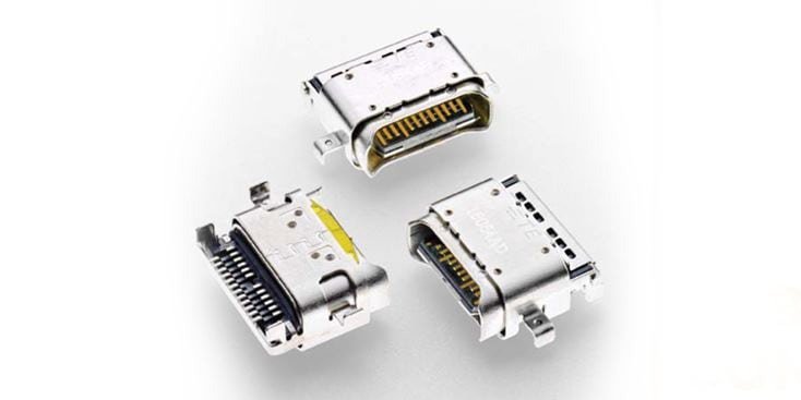 A detailed view of three metallic electronic connectors, showcasing their intricate pin configurations