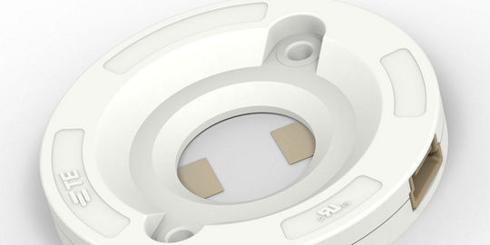 A white circular mounting base designed for secure installations. 