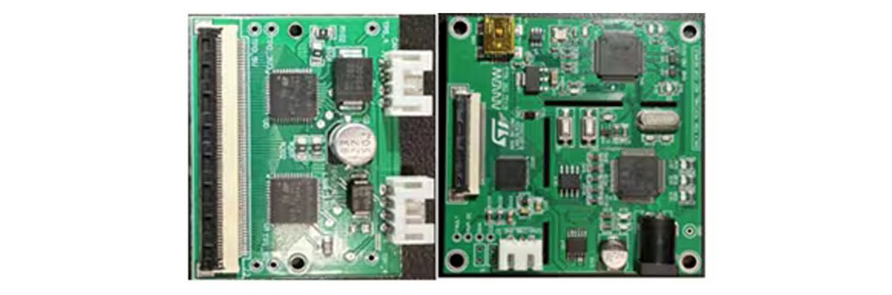 Close-up view of a green circuit board featuring various electronic components, including chips, capacitors, and connectors.