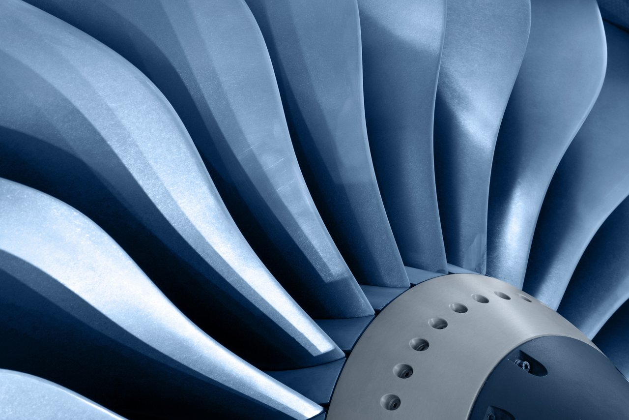 A close-up view of metallic turbine blades arranged in a circular pattern.