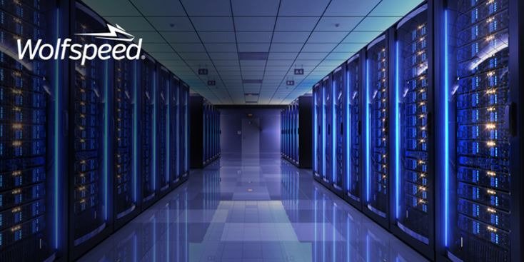 A modern data center featuring rows of illuminated server racks under blue ambient lighting. 