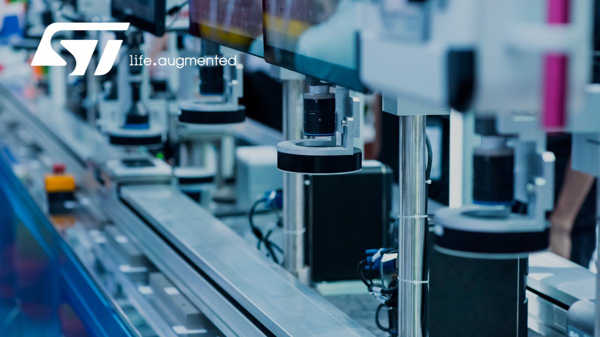 Close-up view of an automated production line in an electronics manufacturing facility. 
